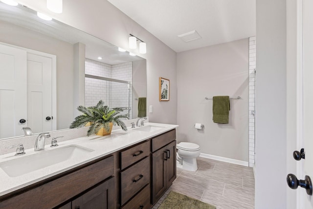 1049 Fabel Ln, Waconia, MN 55387 - full bathroom with a stall shower, toilet, double vanity, and baseboards