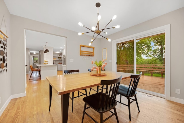 2400 Oakwood Dr, Burnsville, MN 55306 - dining room featuring light wood finished floors, a chandelier, and baseboards