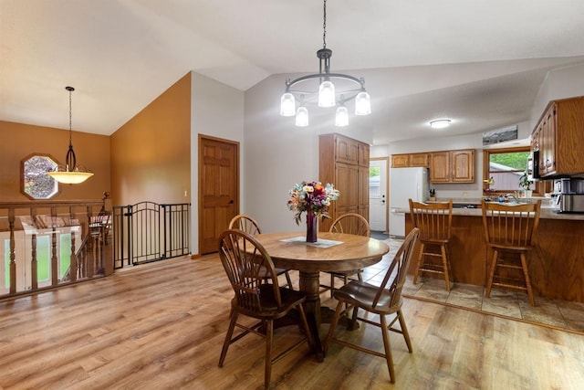 W1618 850th Ave, Spring Valley, WI 54767 - dining area featuring light wood-type flooring, a chandelier, and high vaulted ceiling