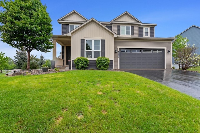 11750 Harvest Path, Woodbury, MN 55129 - view of front of house featuring asphalt driveway, a front lawn, an attached garage, and board and batten siding