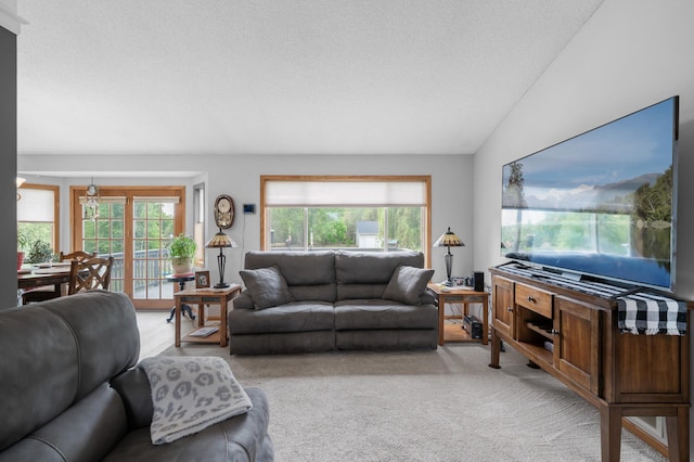 3062 196th Ave NE, East Bethel, MN 55011 - living area with light colored carpet, lofted ceiling, and a textured ceiling