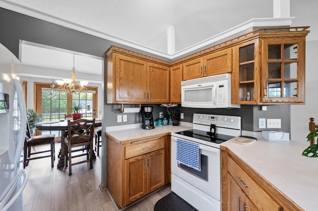 3062 196th Ave NE, East Bethel, MN 55011 - kitchen with white appliances, brown cabinetry, light countertops, a chandelier, and light wood finished floors