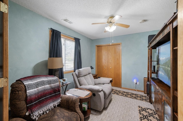 3062 196th Ave NE, East Bethel, MN 55011 - sitting room with a ceiling fan, a textured ceiling, and baseboards