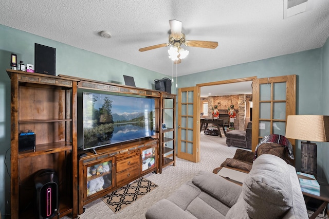 3062 196th Ave NE, East Bethel, MN 55011 - carpeted living area with french doors, a ceiling fan, and a textured ceiling