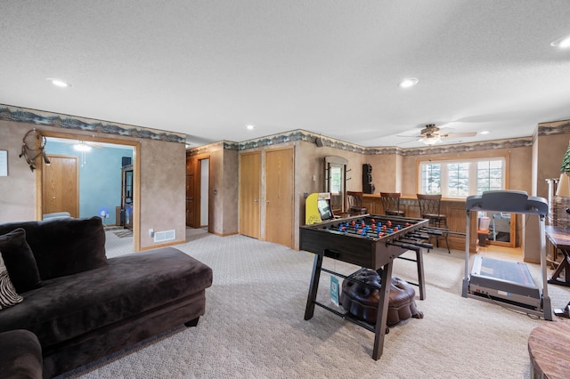 3062 196th Ave NE, East Bethel, MN 55011 - recreation room with light colored carpet, a ceiling fan, a textured ceiling, and recessed lighting