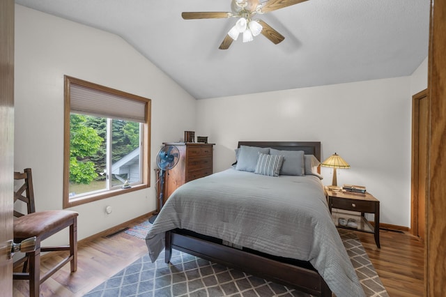 3062 196th Ave NE, East Bethel, MN 55011 - bedroom featuring wood finished floors, vaulted ceiling, baseboards, and a ceiling fan
