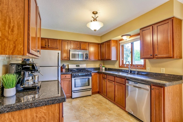 11215 Sumter Ave N, Champlin, MN 55316 - kitchen with stainless steel appliances, a sink, and brown cabinets