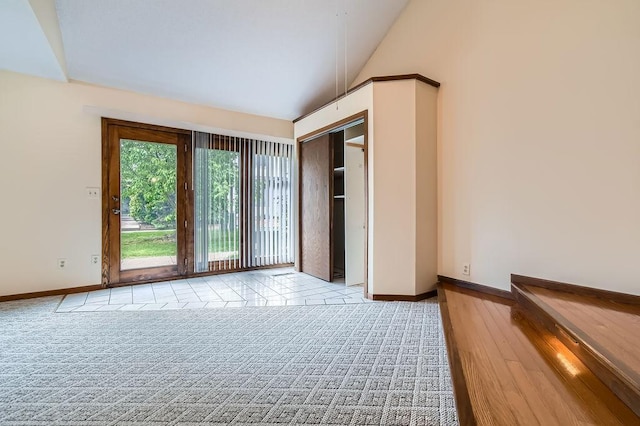 544 Auburn Pl NW Unit C, Elk River, MN 55330 - unfurnished bedroom with lofted ceiling, baseboards, and access to outside