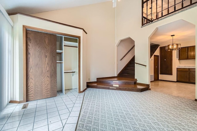 544 Auburn Pl NW Unit C, Elk River, MN 55330 - stairway featuring tile patterned flooring, baseboards, a chandelier, and arched walkways