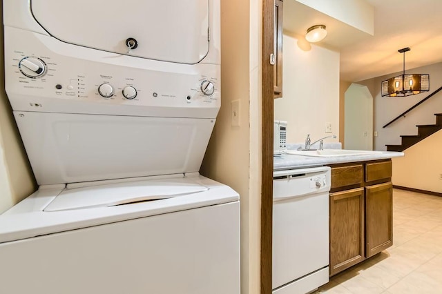 544 Auburn Pl NW Unit C, Elk River, MN 55330 - washroom with stacked washer / drying machine, light tile patterned flooring, and a chandelier