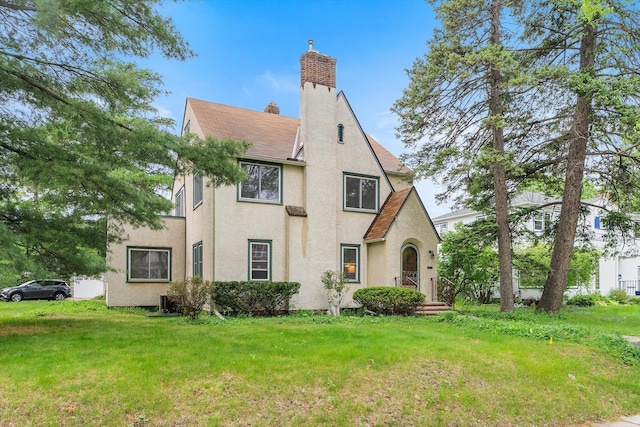 2708 Chowen Ave S, Minneapolis, MN 55416 - tudor house featuring stucco siding, a front lawn, and a chimney