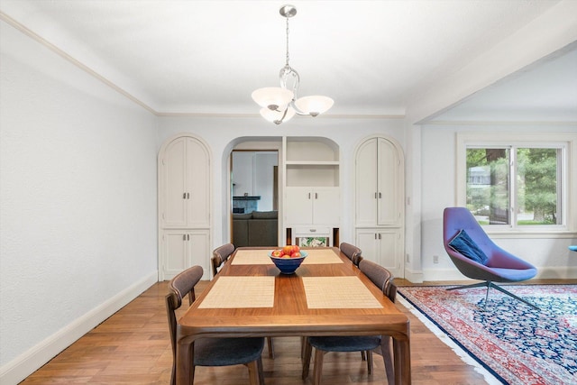2708 Chowen Ave S, Minneapolis, MN 55416 - dining room with a chandelier, baseboards, light wood-type flooring, and arched walkways