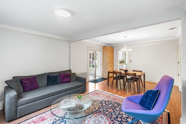 2708 Chowen Ave S, Minneapolis, MN 55416 - living area featuring a chandelier, light wood finished floors, radiator, and baseboards