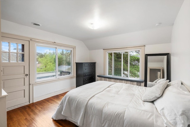 2708 Chowen Ave S, Minneapolis, MN 55416 - bedroom with lofted ceiling, multiple windows, wood finished floors, and baseboards
