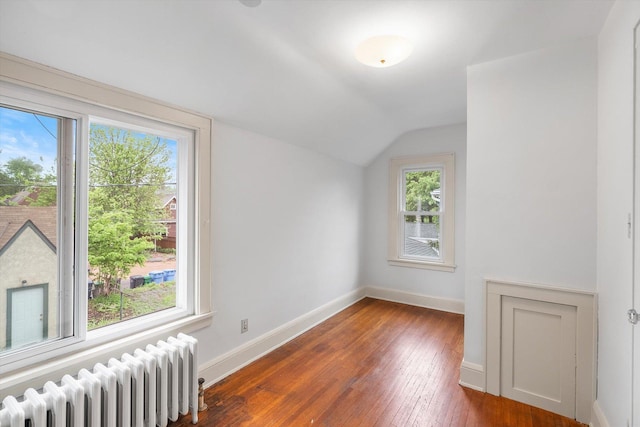 2708 Chowen Ave S, Minneapolis, MN 55416 - spare room featuring radiator heating unit, vaulted ceiling, hardwood / wood-style flooring, and baseboards