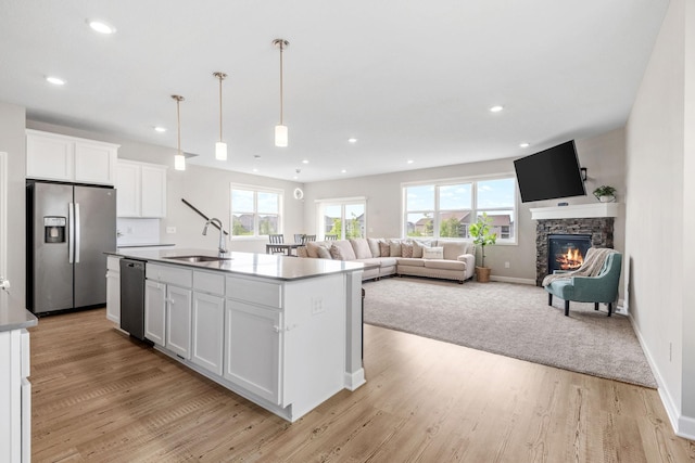 14520 109th Ave N, Maple Grove, MN 55369 - kitchen with appliances with stainless steel finishes, white cabinetry, a fireplace, light wood finished floors, and recessed lighting