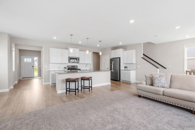 14520 109th Ave N, Maple Grove, MN 55369 - living area with plenty of natural light, light wood finished floors, recessed lighting, and stairs
