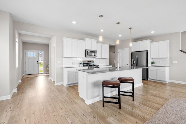 14520 109th Ave N, Maple Grove, MN 55369 - kitchen with appliances with stainless steel finishes, tasteful backsplash, light wood-style flooring, white cabinetry, and recessed lighting