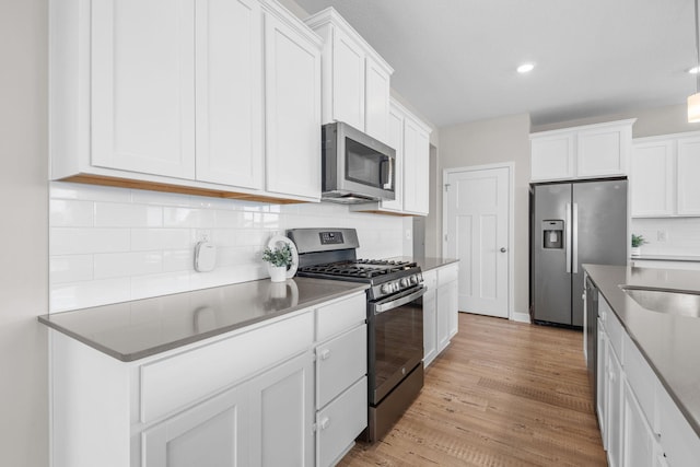 14520 109th Ave N, Maple Grove, MN 55369 - kitchen featuring stainless steel appliances, white cabinets, tasteful backsplash, light wood-style floors, and recessed lighting