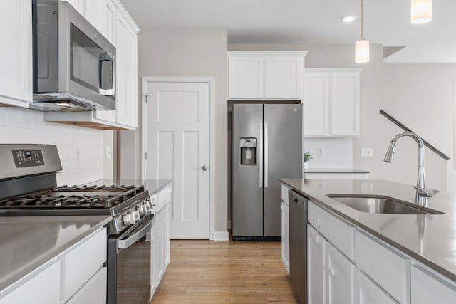 14520 109th Ave N, Maple Grove, MN 55369 - kitchen featuring stainless steel appliances, white cabinetry, backsplash, light wood-style floors, and recessed lighting