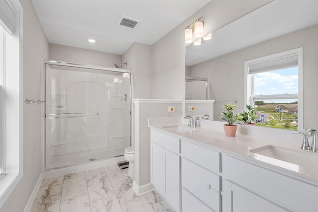 14520 109th Ave N, Maple Grove, MN 55369 - bathroom with marble finish floors, a shower stall, double vanity, and recessed lighting