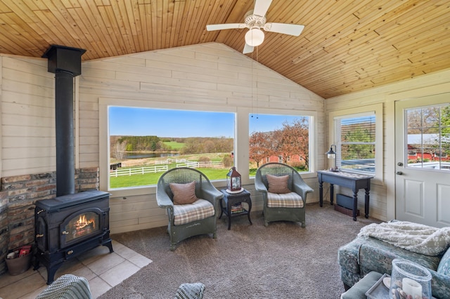 2929 170th St, Frederic, WI 54837 - sunroom featuring lofted ceiling, a wood stove, and a water view