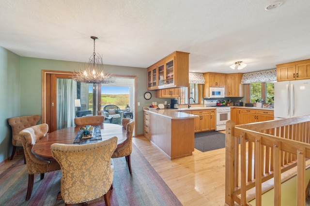 2929 170th St, Frederic, WI 54837 - dining area with a chandelier, light wood finished floors, and baseboards