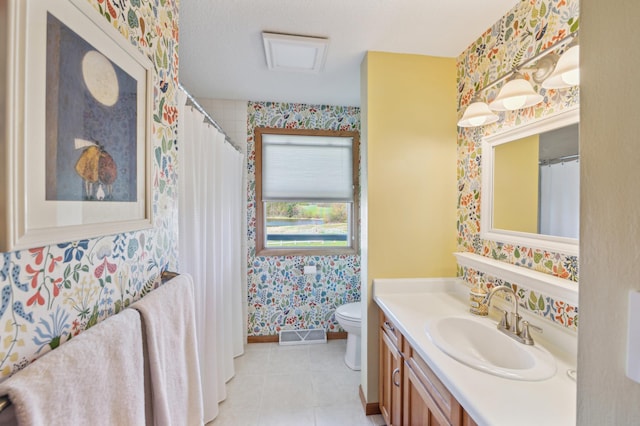 2929 170th St, Frederic, WI 54837 - bathroom featuring wallpapered walls, toilet, baseboards, vanity, and tile patterned floors
