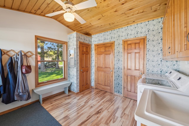 2929 170th St, Frederic, WI 54837 - laundry area featuring cabinet space, washer and clothes dryer, wallpapered walls, wooden ceiling, and light wood finished floors