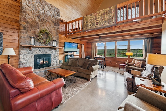 2929 170th St, Frederic, WI 54837 - living room with high vaulted ceiling, concrete flooring, a stone fireplace, wood walls, and wooden ceiling