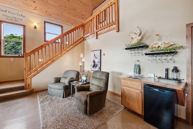 2929 170th St, Frederic, WI 54837 - living room featuring wet bar, wood ceiling, stairway, baseboards, and concrete floors