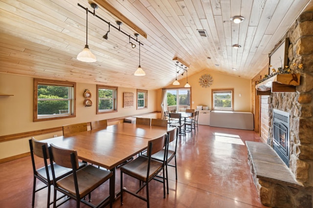 2929 170th St, Frederic, WI 54837 - dining area featuring wood ceiling, finished concrete flooring, a stone fireplace, lofted ceiling, and rail lighting