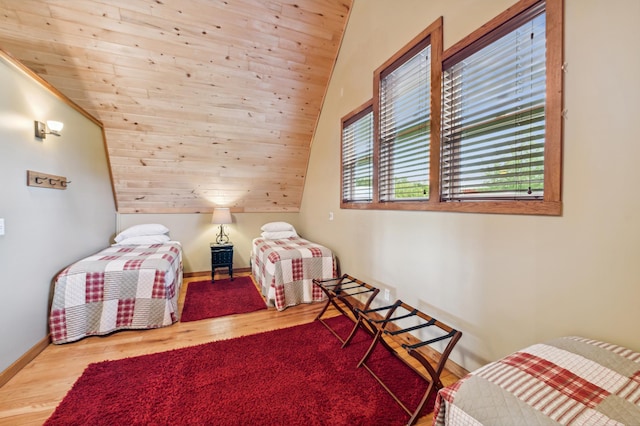 2929 170th St, Frederic, WI 54837 - bedroom featuring wood finished floors, vaulted ceiling, and baseboards