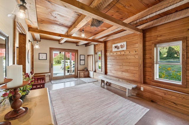 2929 170th St, Frederic, WI 54837 - entrance foyer with wood ceiling with exposed beams, healthy amount of natural light, wooden walls, and concrete flooring