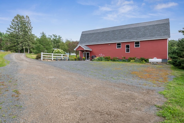 2929 170th St, Frederic, WI 54837 - view of side of home featuring a shingled roof and driveway