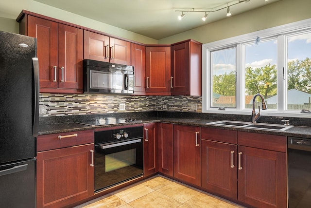 kitchen featuring black appliances, a sink, decorative backsplash, reddish brown cabinets, and light tile patterned floors