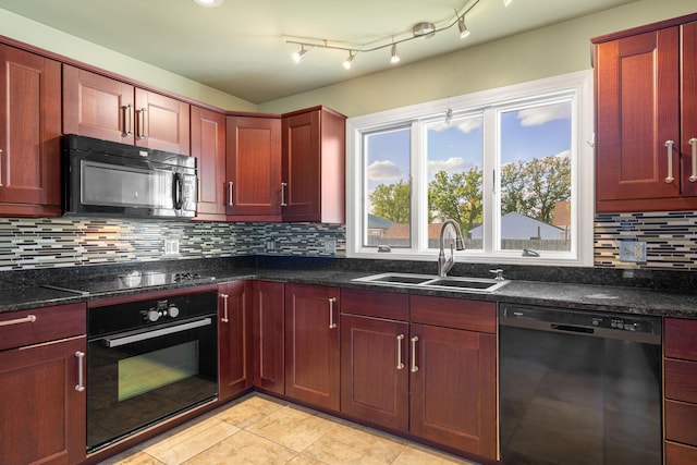 kitchen with black appliances, a sink, decorative backsplash, and reddish brown cabinets