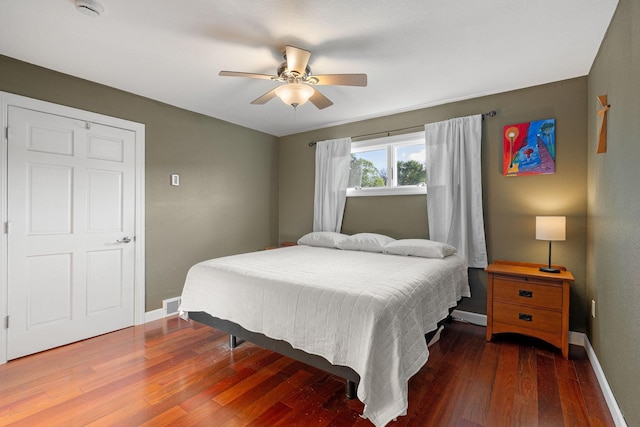 bedroom with baseboards, wood finished floors, and a ceiling fan