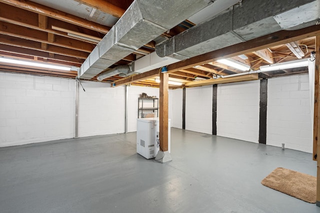 unfinished below grade area featuring concrete block wall