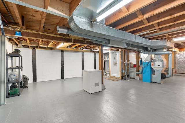 unfinished basement featuring fridge