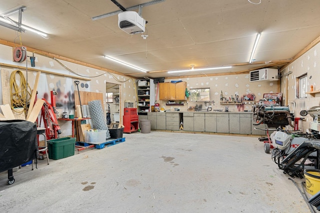 garage with a workshop area and a garage door opener