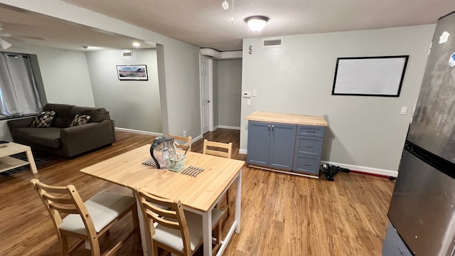 1824 5th St Unit A, Minneapolis, MN 55454 - dining room with baseboards, wood finished floors, a textured ceiling, and ceiling fan