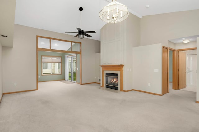 9432 Prairieview Trl N, Champlin, MN 55316 - unfurnished living room featuring ceiling fan, carpet flooring, a large fireplace, baseboards, and high vaulted ceiling