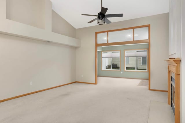 9432 Prairieview Trl N, Champlin, MN 55316 - unfurnished living room with carpet floors, a ceiling fan, a fireplace with flush hearth, baseboards, and lofted ceiling