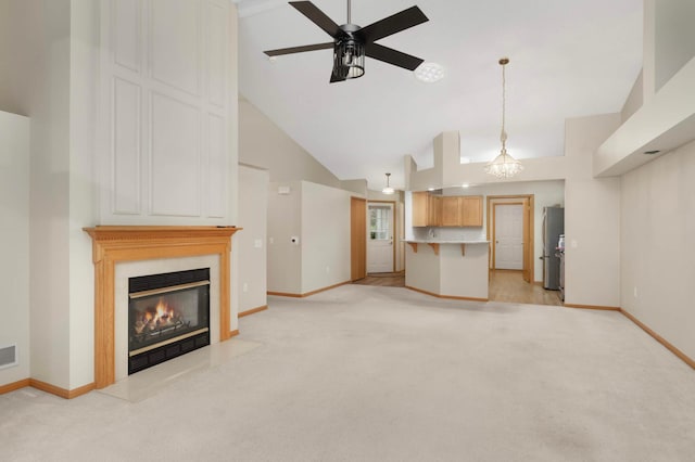 9432 Prairieview Trl N, Champlin, MN 55316 - unfurnished living room with light colored carpet, baseboards, high vaulted ceiling, a ceiling fan, and a glass covered fireplace