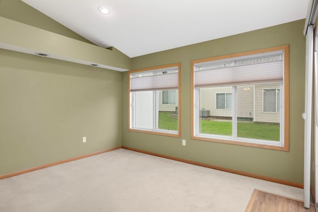 9432 Prairieview Trl N, Champlin, MN 55316 - carpeted spare room with baseboards, vaulted ceiling, and recessed lighting
