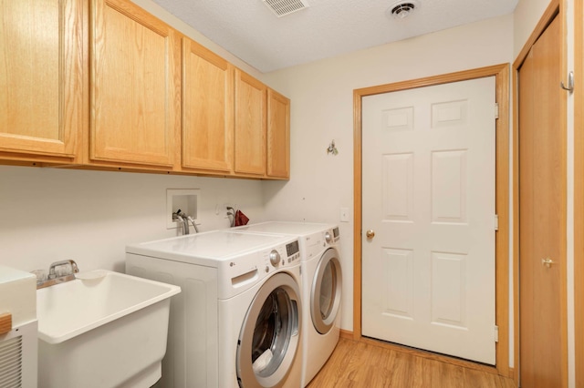 9432 Prairieview Trl N, Champlin, MN 55316 - laundry room featuring cabinet space, light wood-style floors, and independent washer and dryer