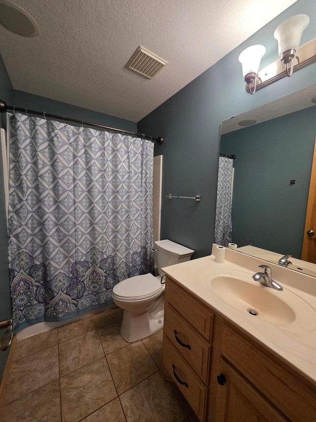 7390 360th St, North Branch, MN 55056 - bathroom featuring toilet, vanity, a textured ceiling, a shower with shower curtain, and tile patterned floors