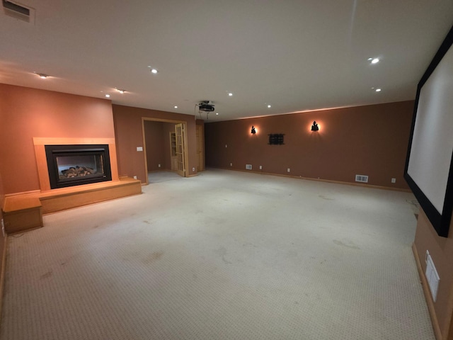 7390 360th St, North Branch, MN 55056 - unfurnished living room with recessed lighting, light carpet, a fireplace with raised hearth, and baseboards