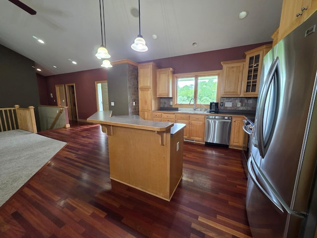 7390 360th St, North Branch, MN 55056 - kitchen featuring stainless steel appliances, lofted ceiling, a breakfast bar, glass insert cabinets, and decorative backsplash